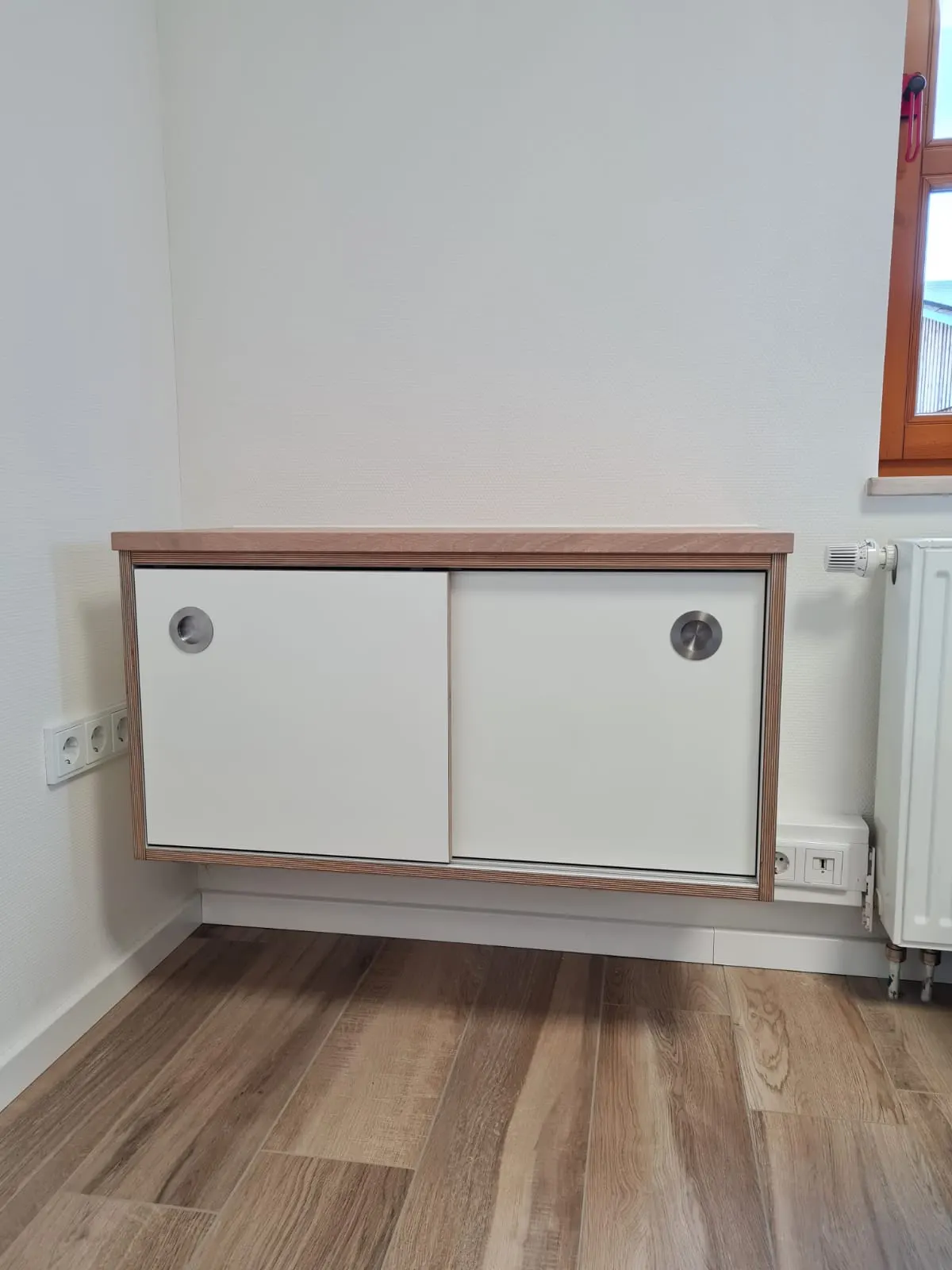 Sideboard nach Maß, eingepasst unter ein breites Fenster